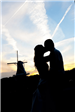 Wedding Couple Kissing at Sunset in Front of the Windmill