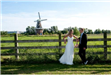 Wedding Couple Posing with the Windmill in the Background