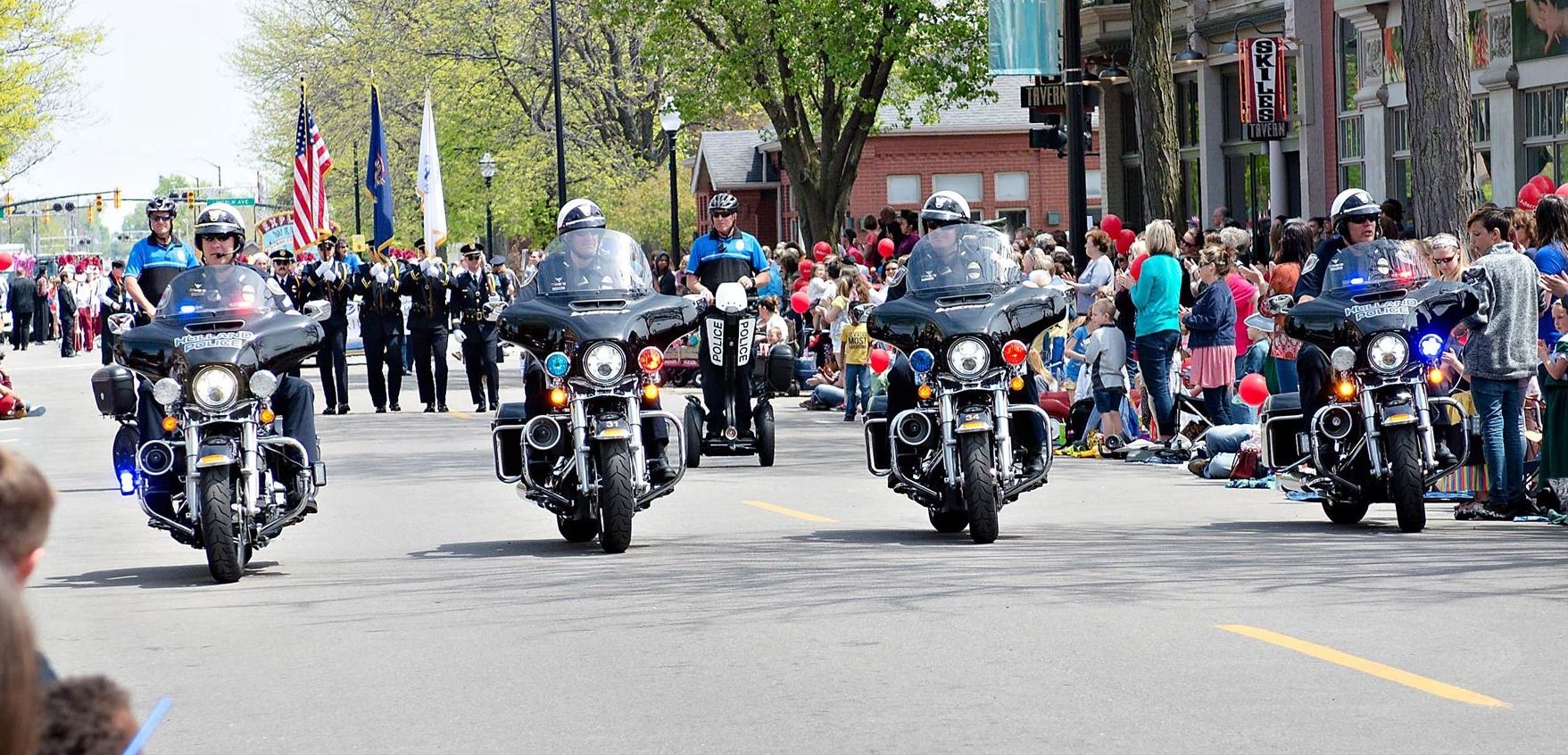 4 officers on motorcycles leading tulip time parade