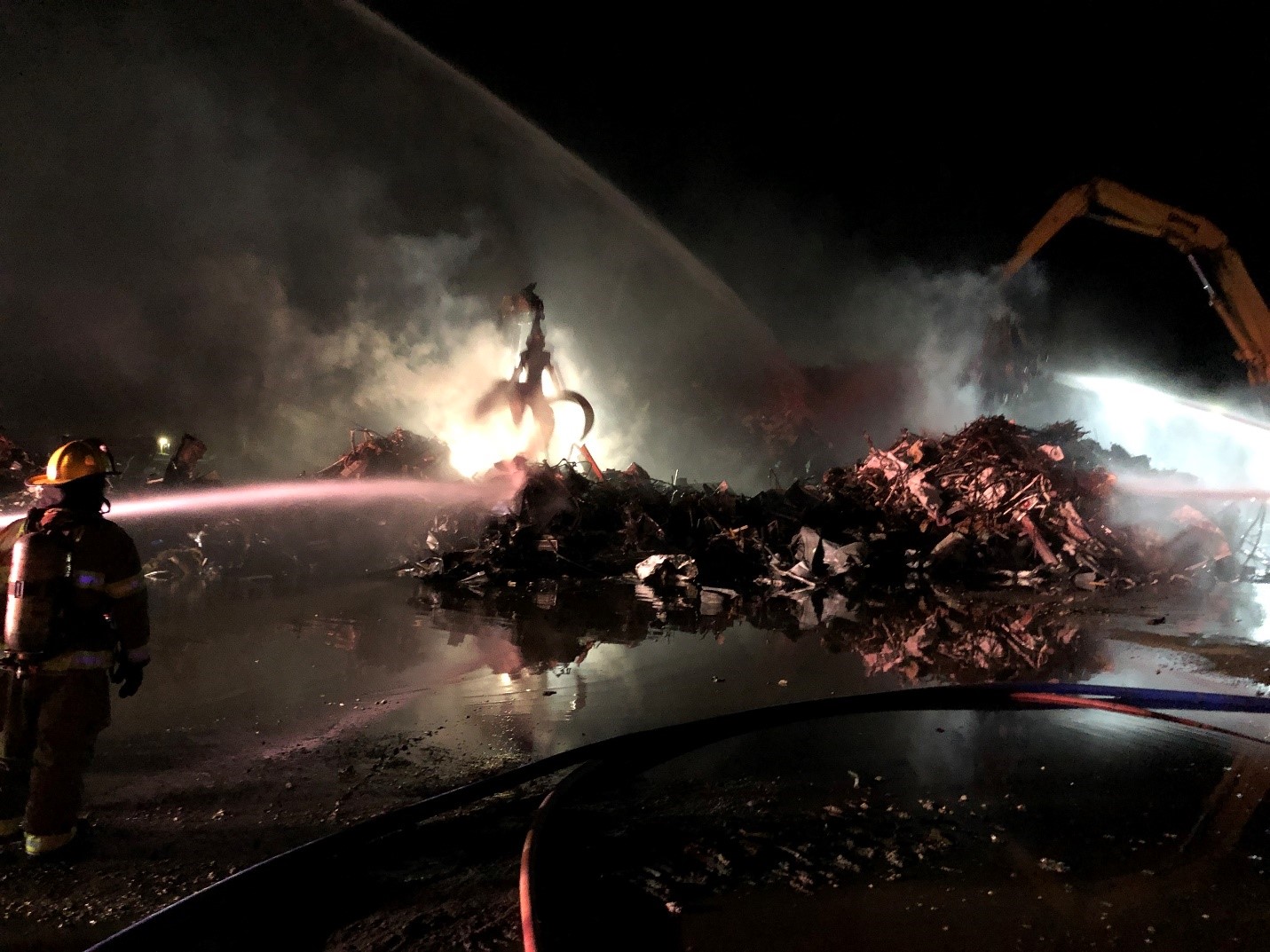 Padnos fire, Firefighters spaying fire with hose