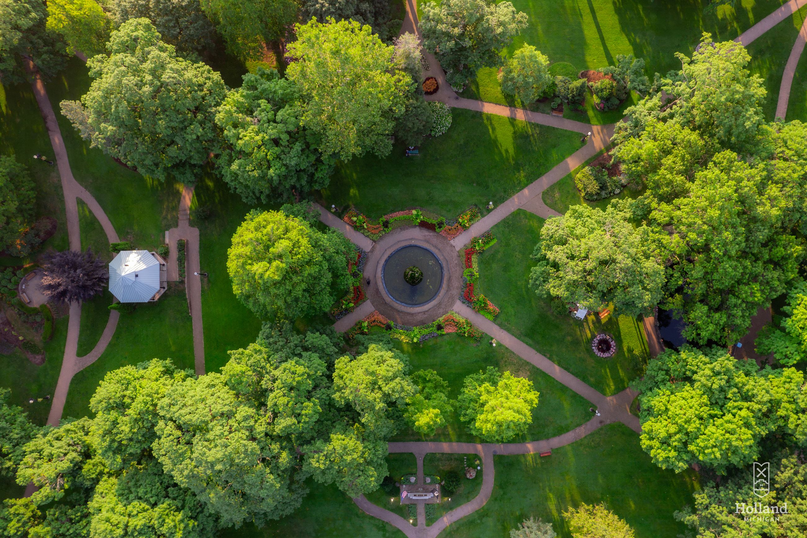 Ariel view of Centennial Park, mature trees with green leaves and a fountain in the center