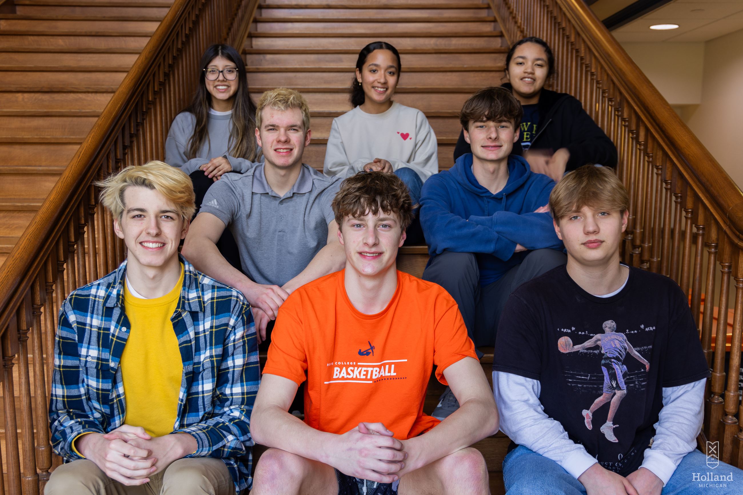 High school students sitting on steps inside City Hall