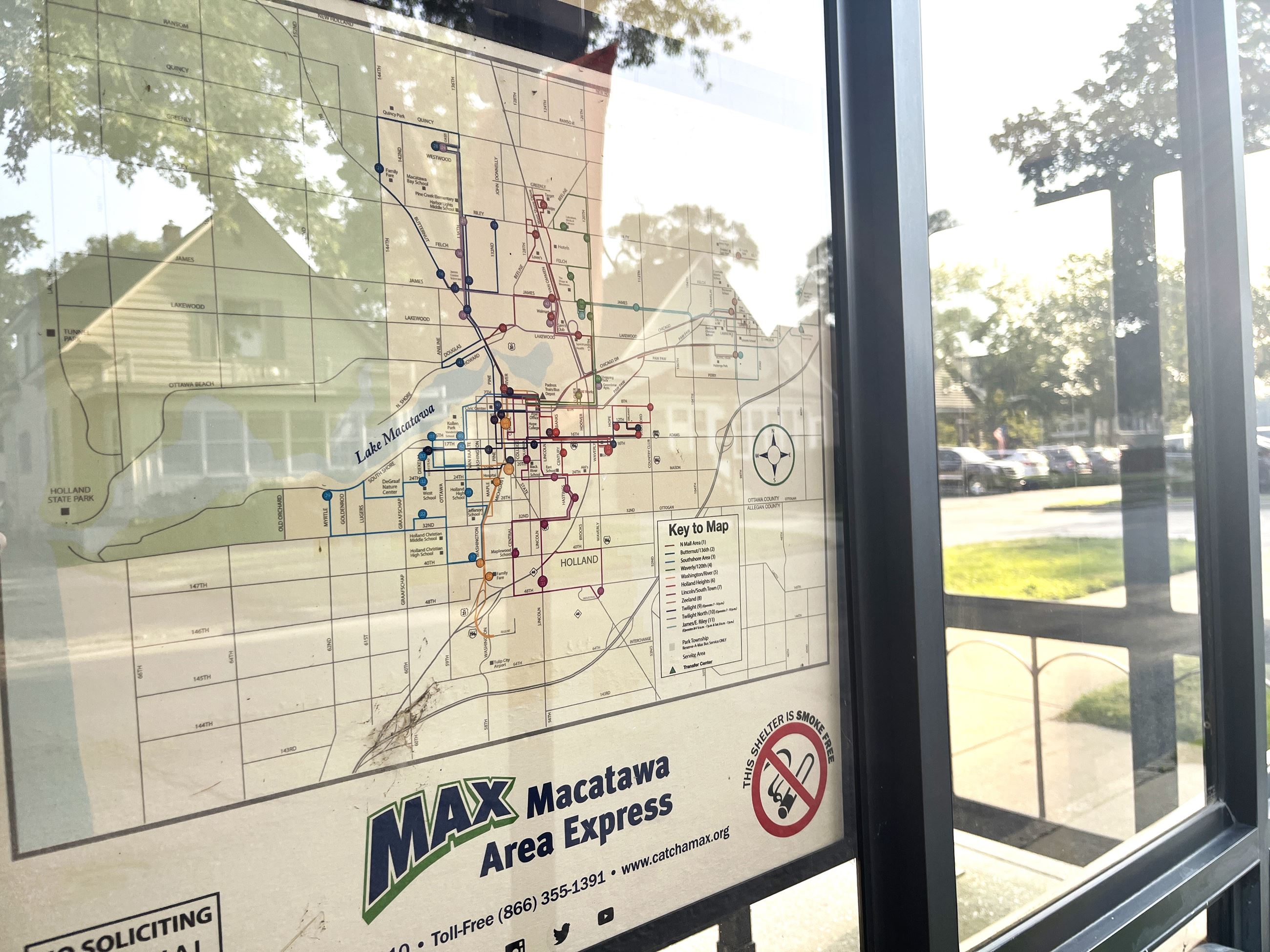 bus route map posted on a kisok with different colored pins as location markers
