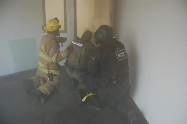 Team Members Crouched at a Door