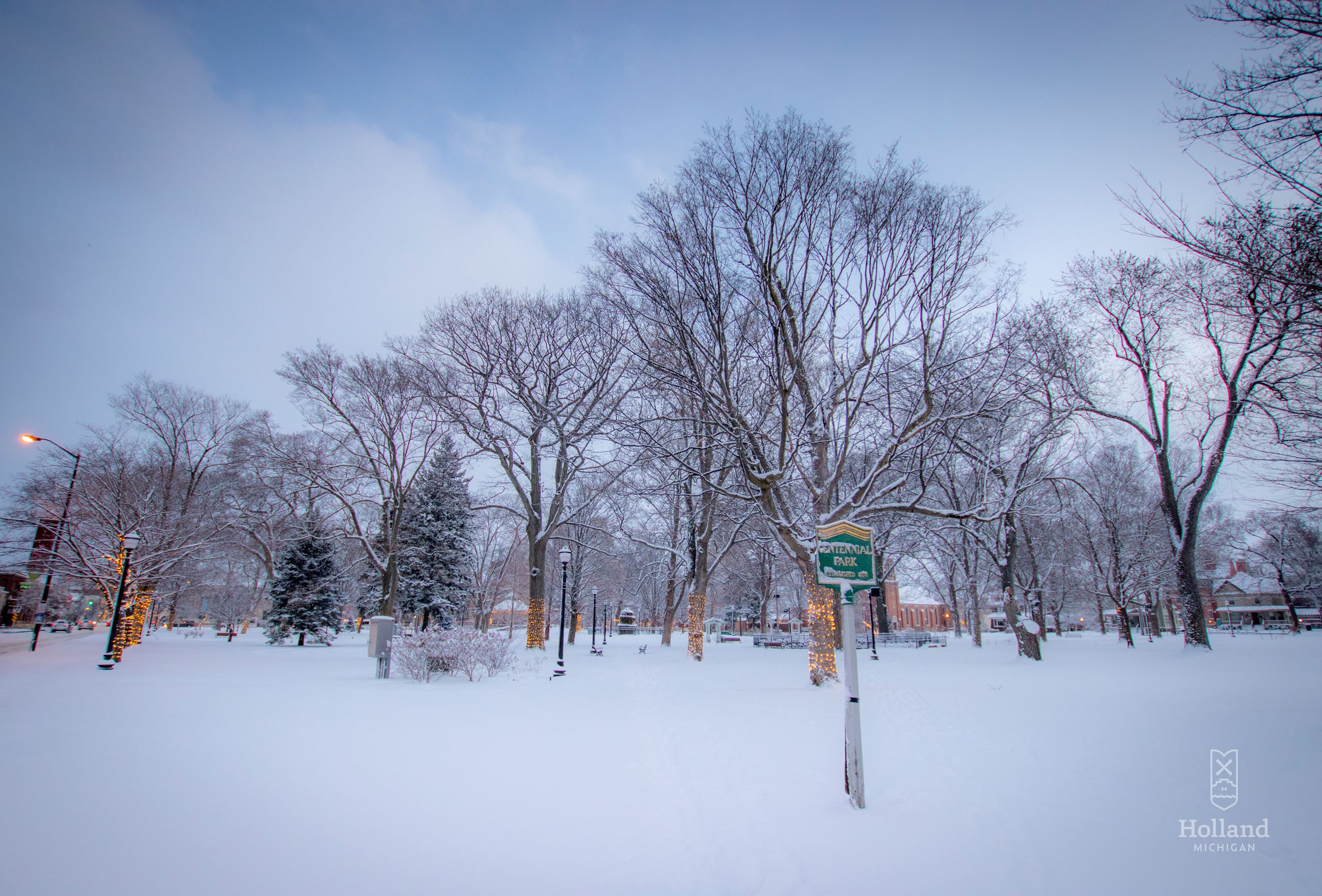 City park covered in snow, with blue sky in the background