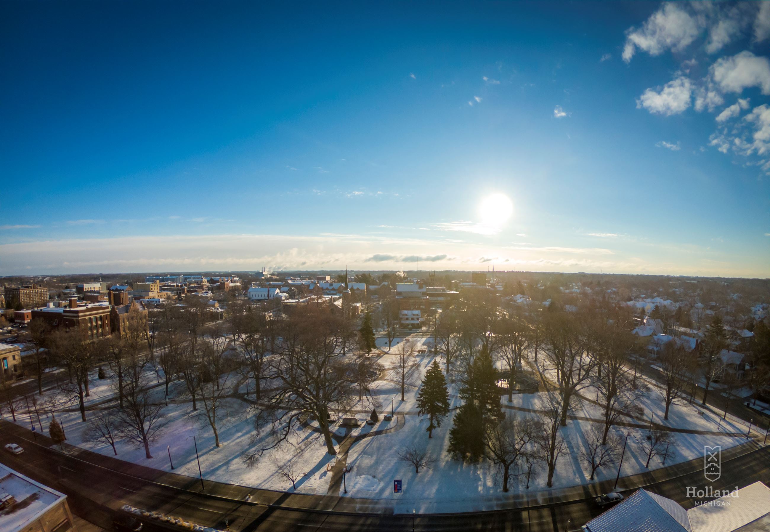 sunrise overlooking snow-covered park in winter with blue sky