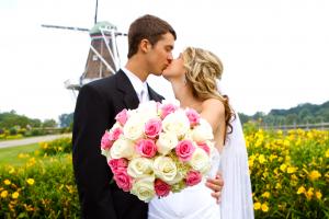 Married Couple Kissing in Front of the Windmill