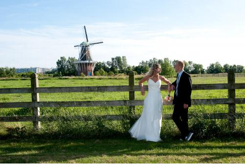 Wedding Couple Posing with the Windmill in the Background